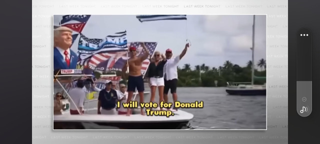 Screenshot of a small yacht with a US and other flags with a bust of Donald Trump and people cheering for him, "I will vote for Donald Trump. "