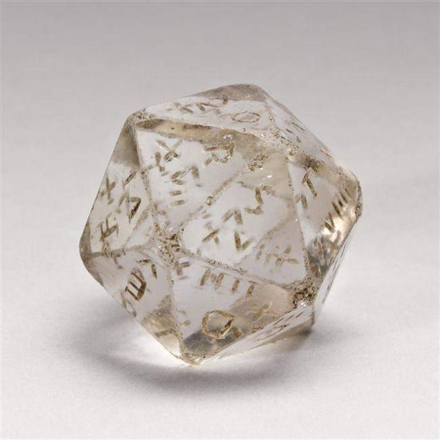 Fully transparent icosahedron as a 20-sided die with Latin letters etched into each side.