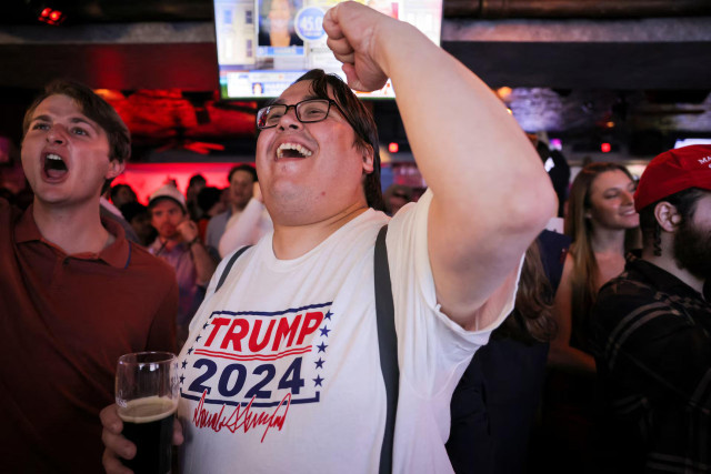 People react to early voting results during a watch party at the New York Young Republican Club watch party in New York City. REUTERS/Andrew Kelly