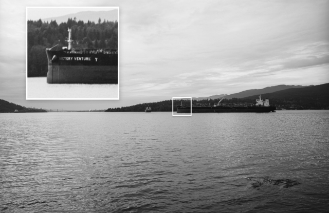 A b&W photo of a ship in the distance with a 6x enlargement of the ship's name in a square on top-left