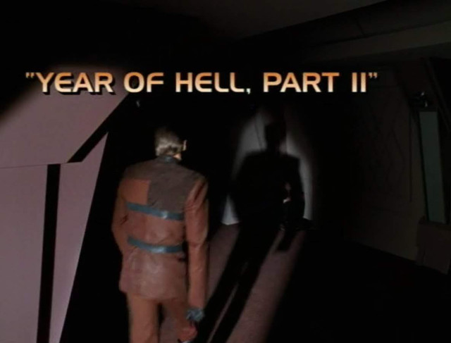 Voyager scene. It's the title card for an episode. We see a guy wearing a brown getup walking away from us, his shadow out head of him. Title card reads, "YEAR OF HELL, PART II"