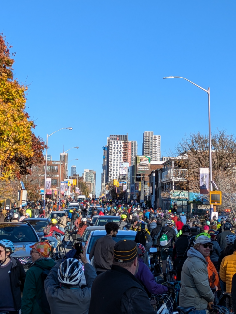 Street densely filled with people on bicycles.