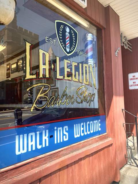 Picture of the finished gold leaf window at La Legion Barbershop