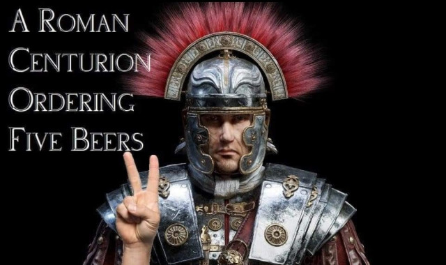 Photo of a man dressed as a Roman Centurion, holding up his right hand. He has his index and middle finger up, in a V shape. 

Meme text reads, "A Roman Centurion ordering five beers."