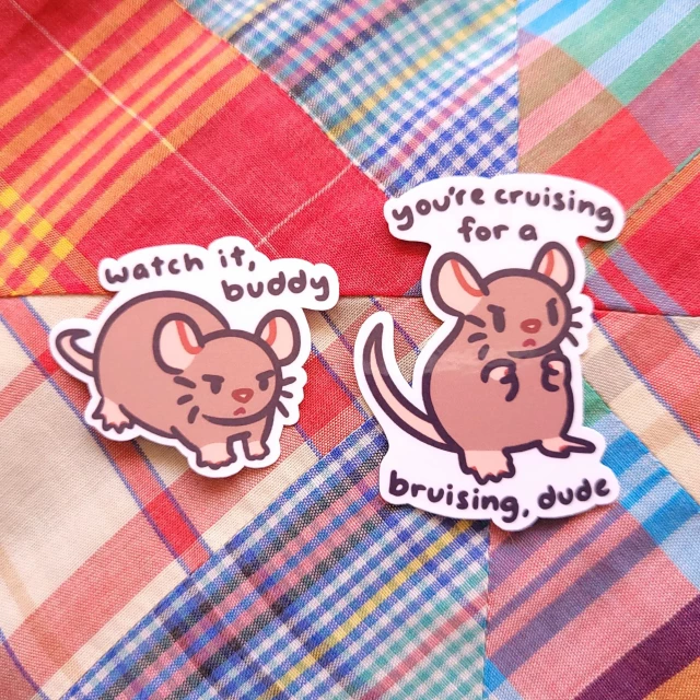 rat anger scale sticker set
1. "watch it, buddy" a brown rat with narrowed eyes.
2. "you're cruising for a bruising, dude" a brown rat standing on their hind feet, paws up in the air, as if ready to fistfight