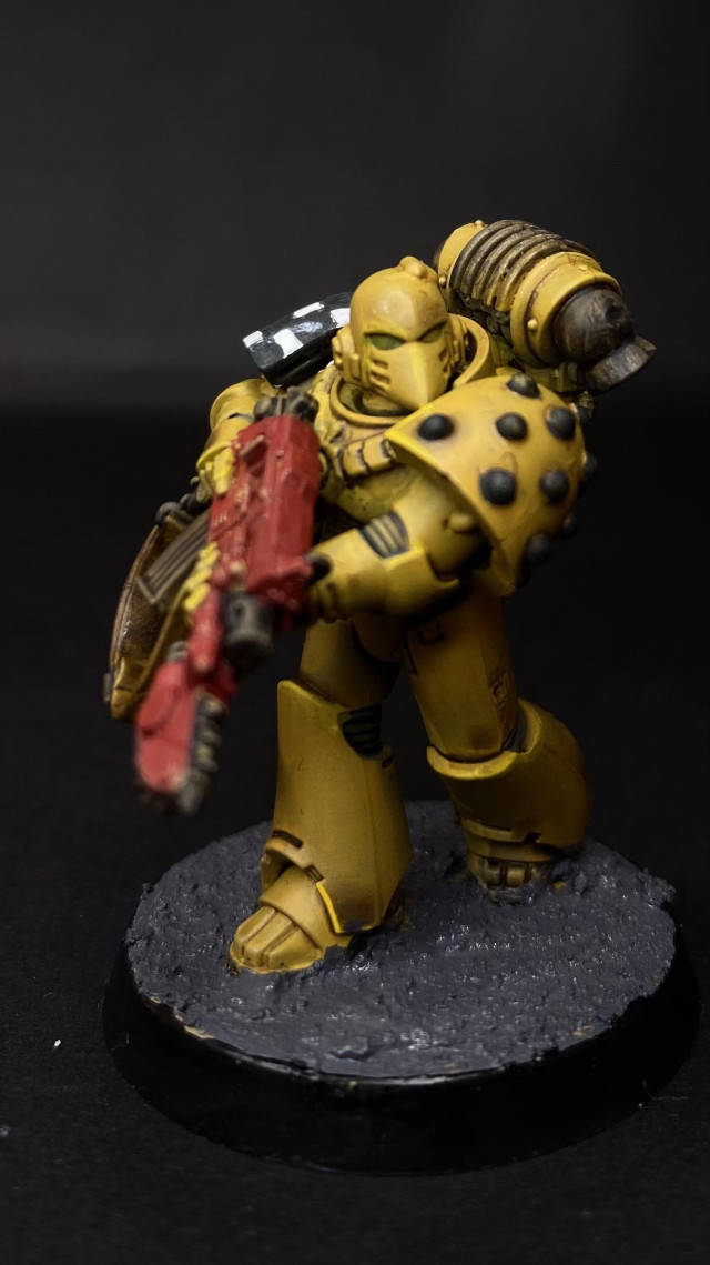 Front of a Lamenters Space Marine. Yellow armour, red cased bolt gun. 