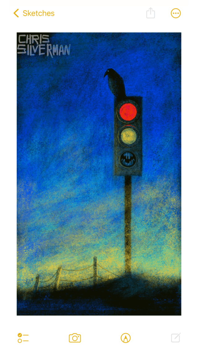 A large traffic light stands in the middle of nowhere, with only a wire fence in the background. The sky is the deep blue of either dawn or dusk, with golden light on the horizon. The red aspect is brightly lit, the yellow aspect is dimly lit, and where the green aspect would be is a black mouth with fangs. As if that weren't unsettling enough, a crow is perched on top of the light.