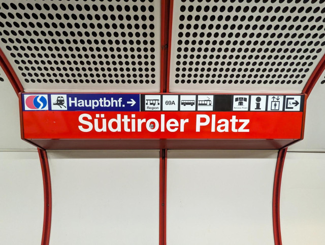 Stationsschild Südtiroler Platz. Helvetica auf rotem Grund