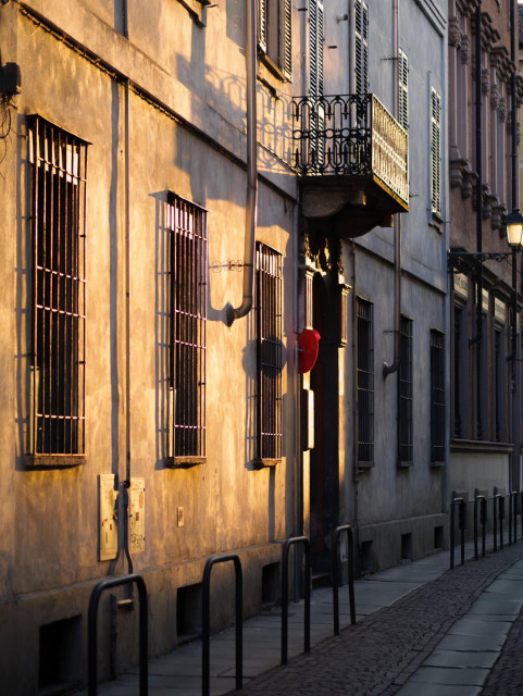 Late afternoon sunlight on an old building facade viewed from an angle.