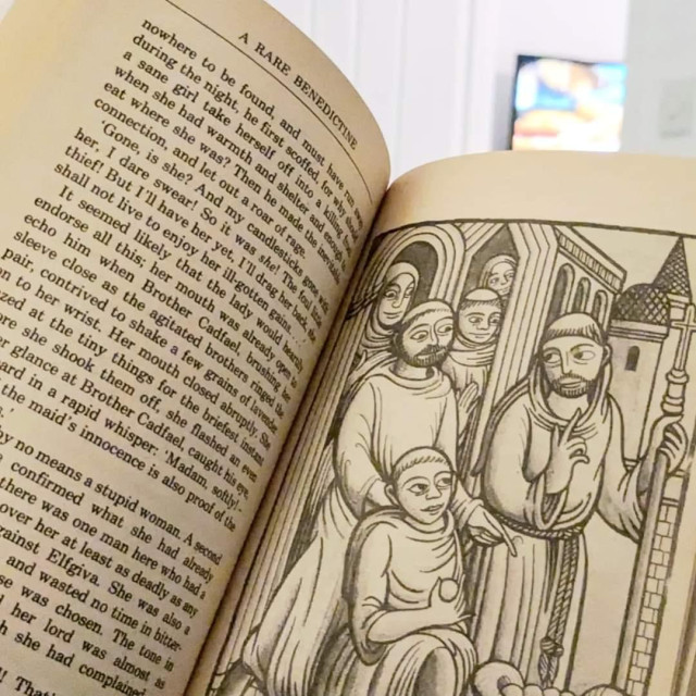 Photograph of the interior of A Rare Benedictine, showing an illustration featuring a group of monks in a style inspired by medieval carvings.