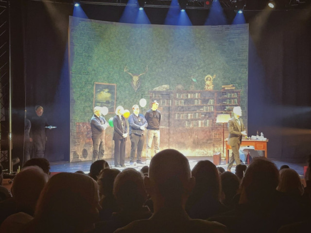 Photo of a stage with illusionist Henrik Fexeus and guests from the audience on stage.