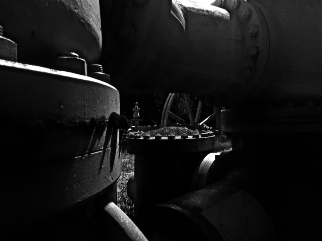 Convoluted pipes and bolts in daylight.