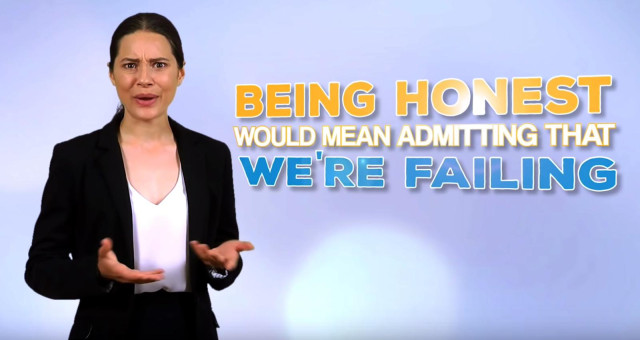 Screen grab from linked video. Government spokesperson looks into the camera and says, "Being honest would mean admitting that we're failing."