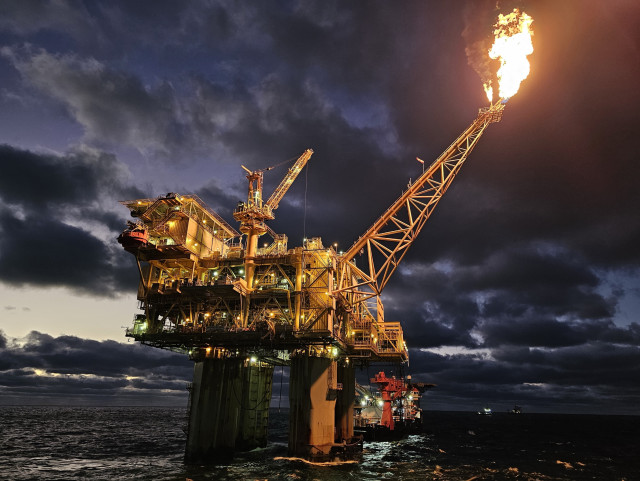 An offshore oil drilling platform rig Marco Polo being used to destroy our planet's climate in the late evening.