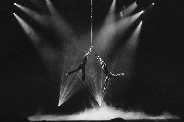 Couple on a stage performing on aerial straps