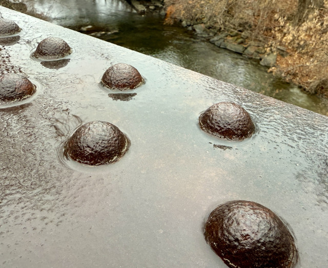 Railroad trestle big rivets in steel overlooking river