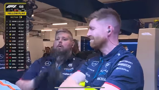 Two Williams mechanics. One with a shocked look on his face. The other looookg like his pet was killed. 