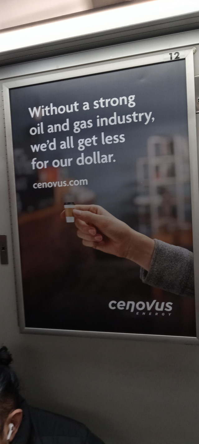 A subway ad that reads "without a strong oil and gas industry, we'd all get less for our dollar. Cenovus"
A picture is a hand holding a doll house sized coffee cup.