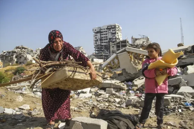 Mine Zaanin, a 63-year old grandmother, is collecting firewood with her granddaughter.