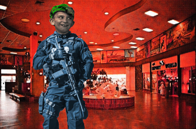 A heavily armed and armored figure with the head of a foolishly grinning 19th century newsie. He stands in the atrium of a pink, vintage mall.