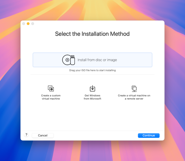 Screenshot of VMWare Fusion running on my Mac: a dialogue window titled Select the Installation Method with the Install from disc or image option selected. Other options are Drag your ISO file here to start installing, Create a custom virtual machine, Get Windows from Microsoft, and Create a virtual machine on a remote server. The dialogue has buttons for help, Cancel, and Continue (focussed).