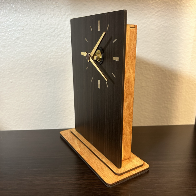 Monolith clock in walnut panel from right side angle showing frame