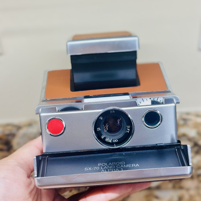 A photo of a popped up Polaroid SX-70