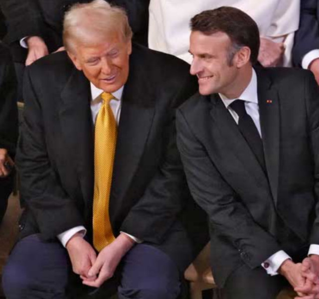 Macron leaning into a smiling Trump like a giddy schoolboy.