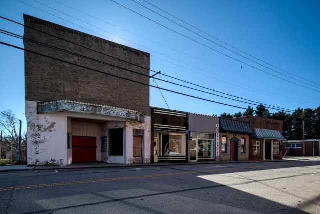 A row of buildings in downtown Yanceyville. An abandoned theater stands out on the left of the image.