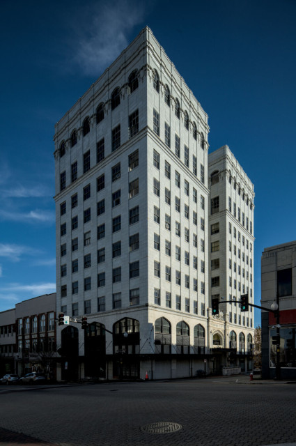 A lens shifted image of the ten story stone Masonic temple at the corner of Union St.