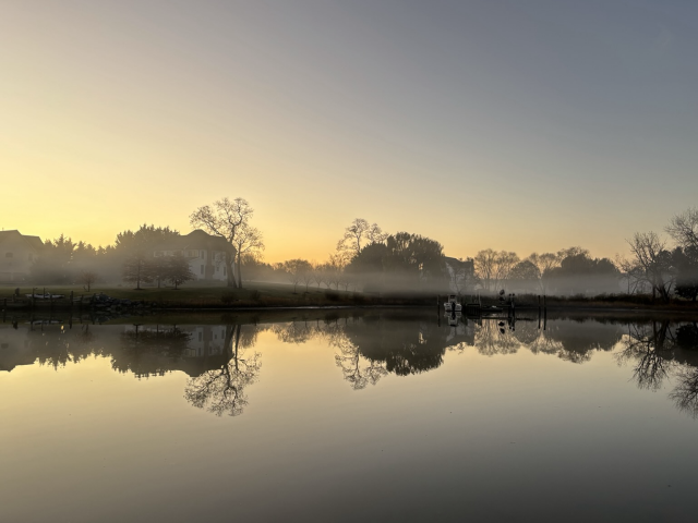 Fog hanging over the water at sunrise 