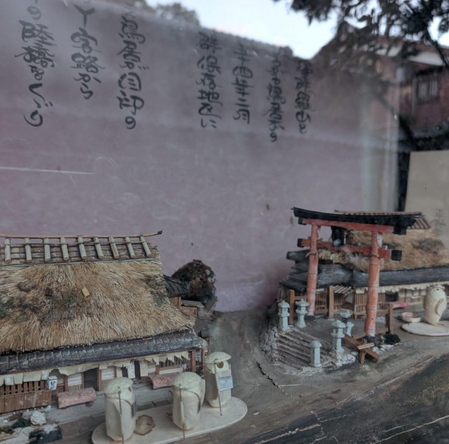 vintage model of traditional architecture, thatch-roofed houses, and trees all around 