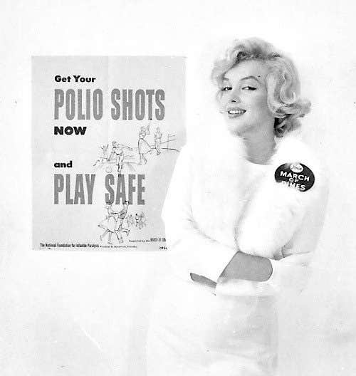 Marilyn Monroe with a glamorous expression and glamorous clothes, leaning against a poster that says "Get your polio shots now and play safe!"