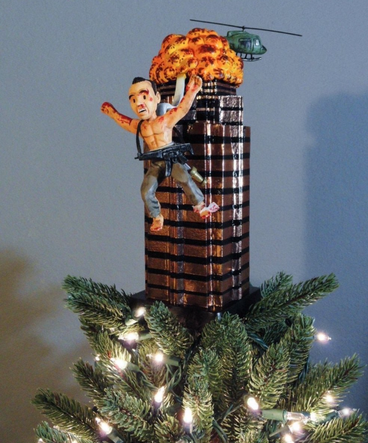 A Christmas tree topper that is a cartoon John McClane jumping from an exploding Nakatomi building. 