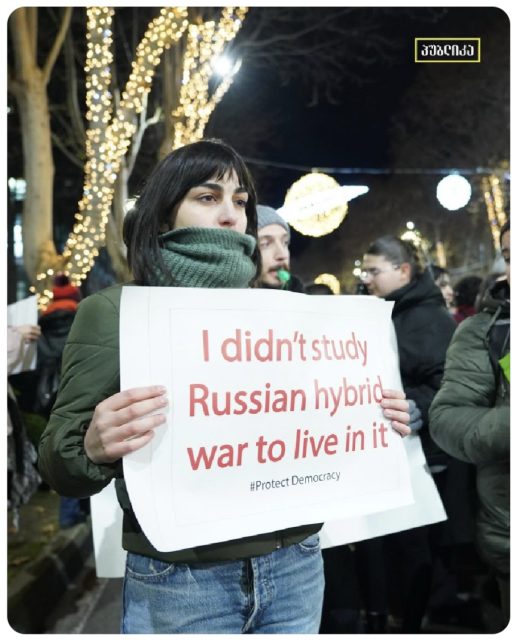 Student protestor in Tbilisi Georgia holds up a sign saying 'I didn't study Russian hybrid war to live in it.'

Photo: Publika Georgia