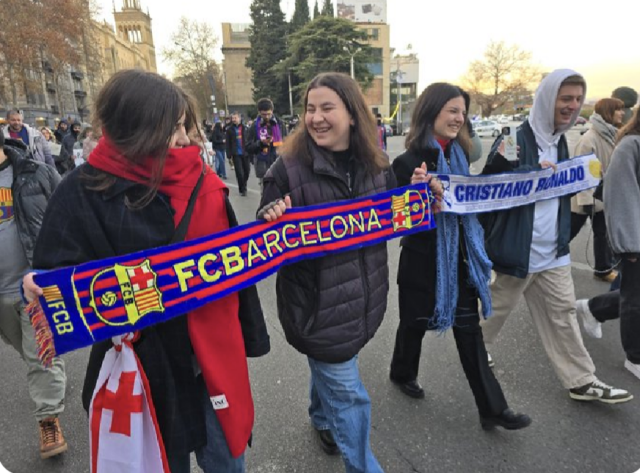 Protestors in Tbilisi, Georgia with Barcelona and Real Madrid football scarves in a solidarity march against the government.

Photo by Mariam Nikuradze