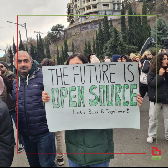 Tech workers protesting in Tbilisi, Georgia hold a banner saying 'The future is open source. Let's build it together.'