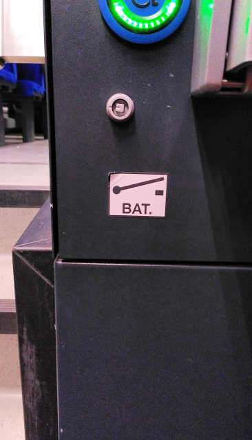 A sticker with the electrical symbol for a switch, and the label "BAT."