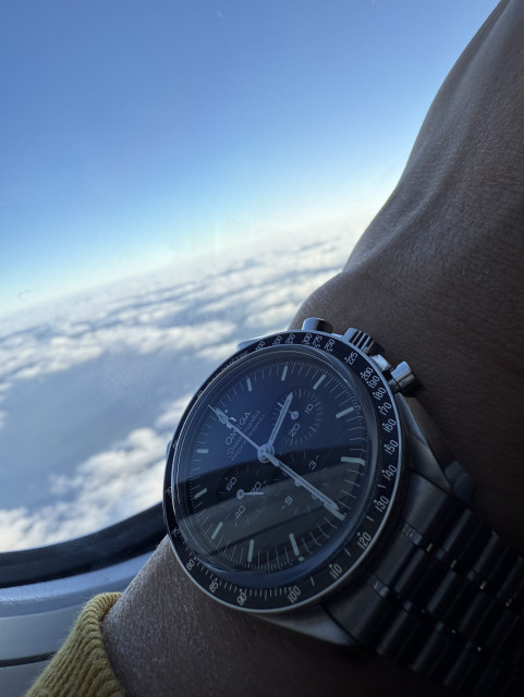 Omega Speedmaster overlooking clouds. 