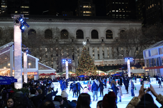 Ice Skating rink at Bryant Park with a Christmas Tree in the background.