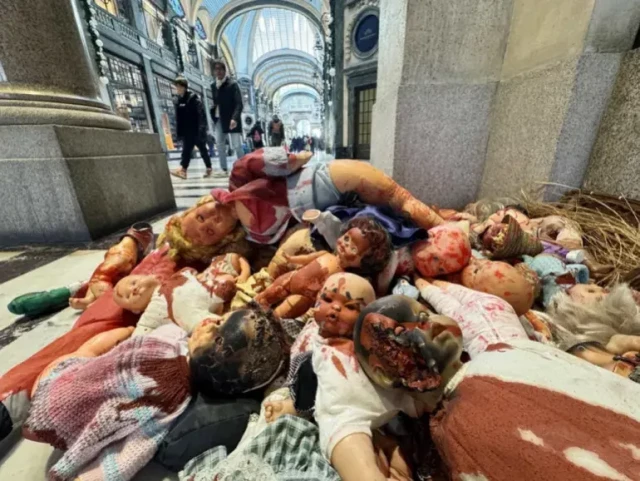 Dolls splattered with a red solution to resemble blood are piled up in the San Federico Gallery to symbolise the thousands of Palestinian children killed by Israel’s military in Gaza [Alessandro Di Marco/EPA]