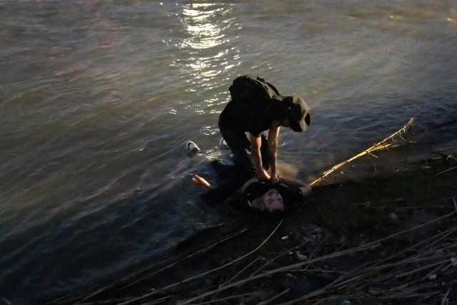 In the early evening of Feb. 24, a small group of Guatemalan migrants approached the Rio Grande at Piedras Negras carrying their belongings, led by their coyote (smuggler guide) as they sought to cross to Eagle Pass, Texas.

Photographer Cheney Orr saw them enter the water. At first they seemed nervous but excited. But it soon became clear the current was strong and the group lost their footing and returned to the Mexican side.

Then they decided to try again.

This time the mood was more somber. A U.S. National Guard officer arrived on the opposite bank and shouted at them in Spanish through a megaphone to return, telling them the river was dangerous.

This time, as they reached the center and again lost their footing, they became separated and were dragged away by the current.

Men came running to help and managed to grab one of them, pull him out of the water and resuscitate him. It turned out to be the smuggler, who was escorted away from the river by authorities, along with other survivors of the incident. Reuters was unable to establish his name or what happened to him afterwards.

Orr did trace the families of two of the migrants who drowned in the failed crossing attempt - 25-year-old Rossanna and her partner, 26-year-old Widman.

Exact numbers are hard to come by, but a recent investigation by the Washington Post and others found at least 1,107 people drowned trying to cross the Rio Grande between 2017 and 2023.