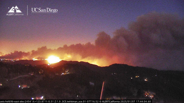 Flame visible, clouds of smoke over Topanga and Pacific Palisades, California