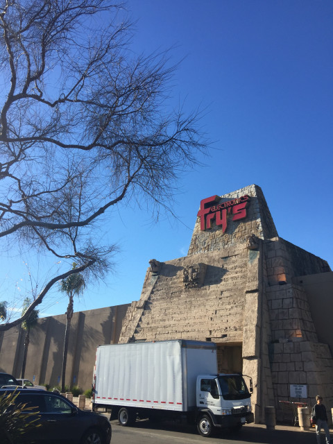 An Aztec inspired storefront with a white delivery truck parked in front. 