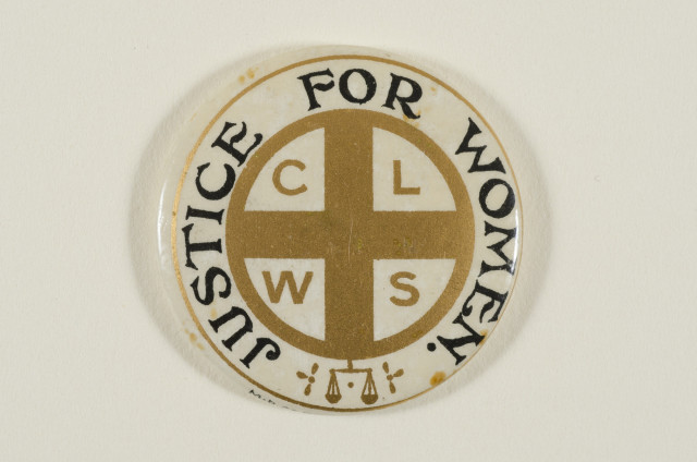 Photograph of a badge that reads "Justice for women" around the circumference, with the acronym "CLWS" in the centre wiuth a cross. This is a  Church League for Women's Suffrage badge, c.1913.

(Badge, paper, metal, round, printed with a gold cross and border, white background, gold inscription: 'CLWS, Justice for Women', produced by the Church League for Women's Suffrage. 7EWD/M/23 https://flic.kr/p/AhCKDS )