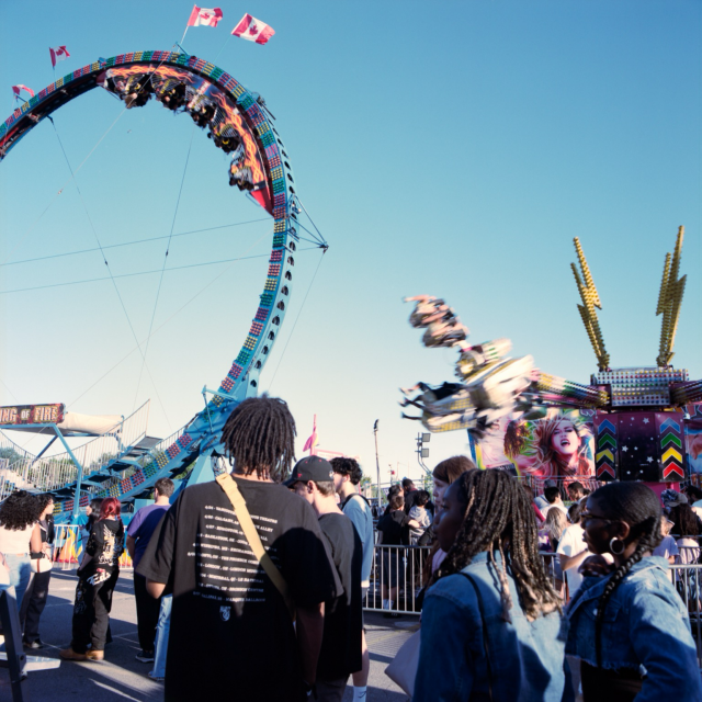 A loop ride and a spinning swing type ride compete for attention of the crowds. 