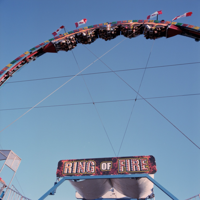 The Ring Of Fire takes its riders on a 360 loop against a clear blue sky. 