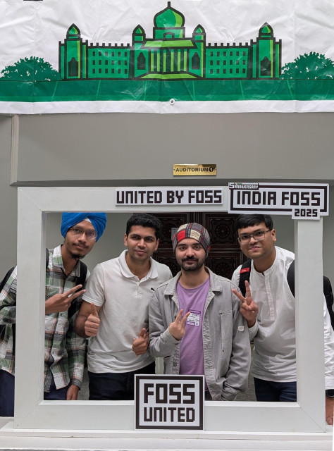 Four Inkscape contributors posing for a picture behind the IndiaFOSS 2025 photo booth.