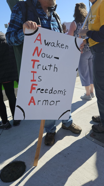 sign reading AWAKEN NOW TRUTH IS FREEDOMS ARMOR