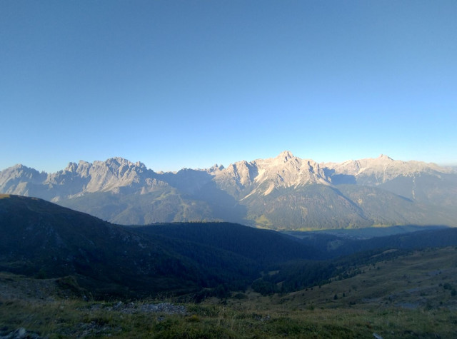 In the morning at Sillianer Hütte: The Sexten Dolomites are illuminated by the rising sun. The Valley still lies in the shadows.